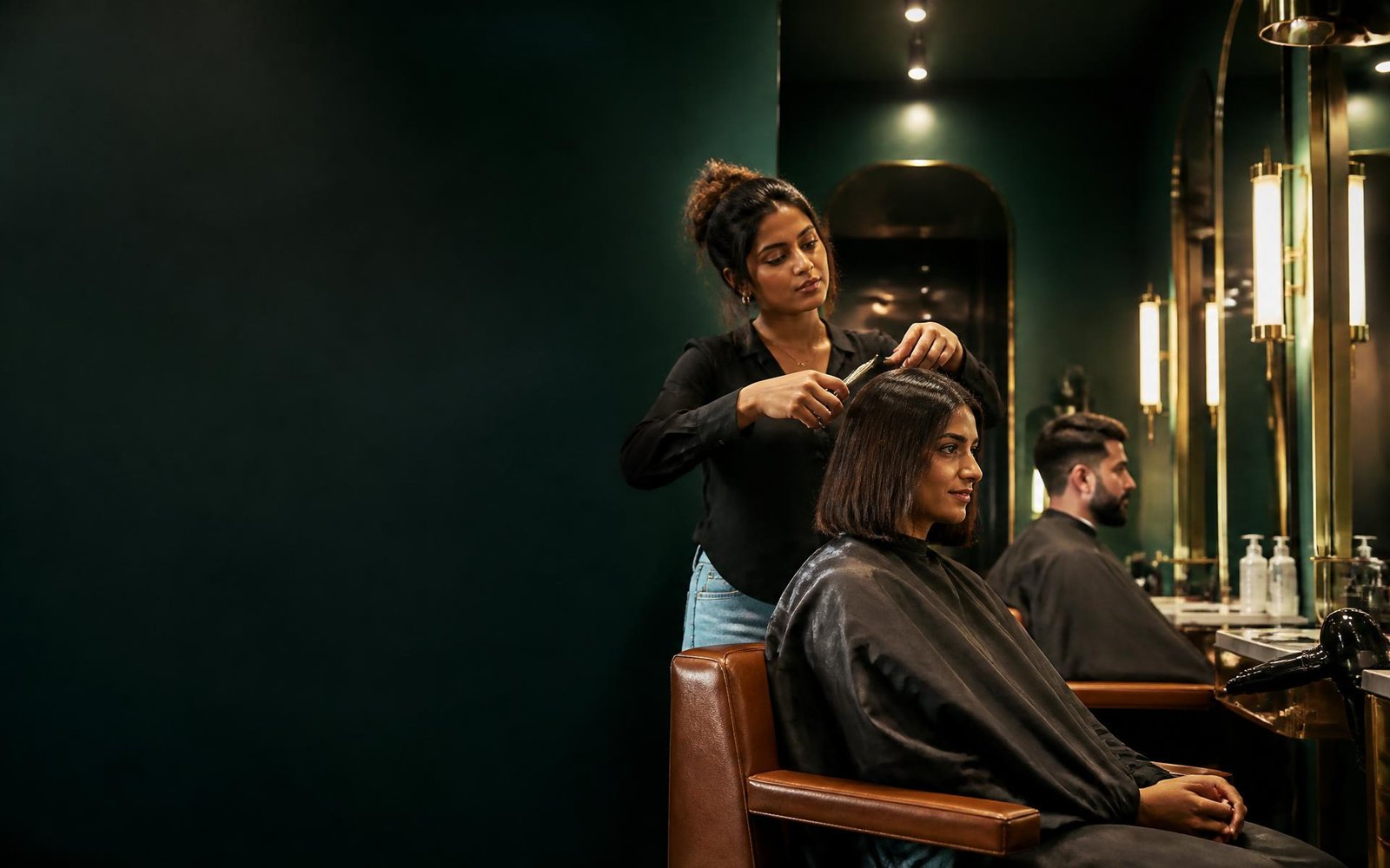 Indian hairstylist creating a polished haircut in a premium salon